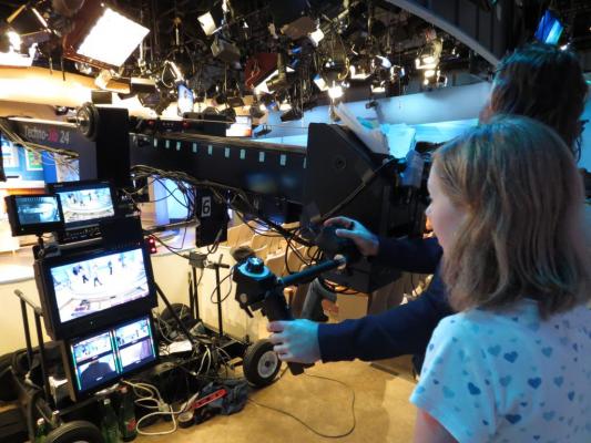 Sylvia standing with the jib camera operator on stage at ABC studios in New York for the Katie Couric show.