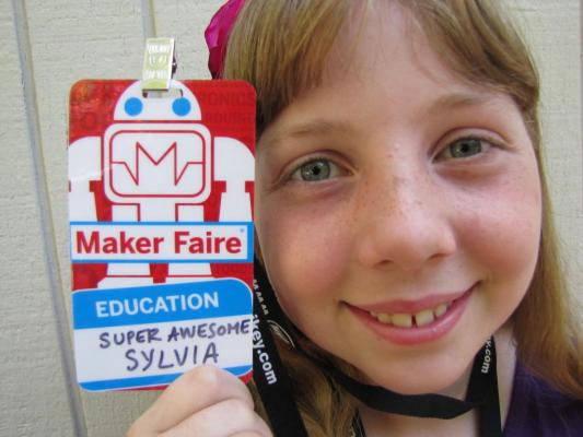 Sylvia posing with her preliminary Maker Faire Badge