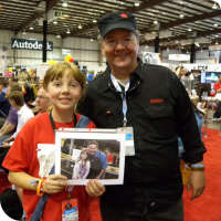 Sylvia posing with Dale Dougherty holding a picture of them at Maker Faire 2011