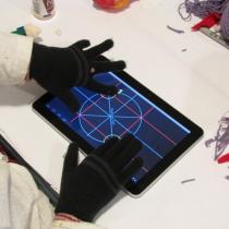 Sylvia uses a capacitive touchscreen on a tablet computer with gloves on