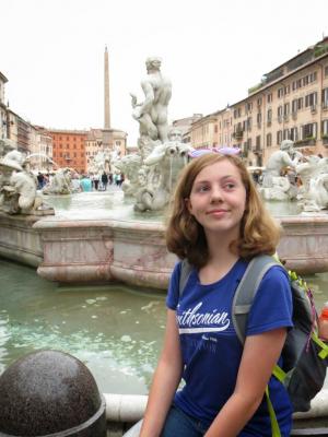 Sylvia sitting on the rim of a fountain in Rome, Italy.