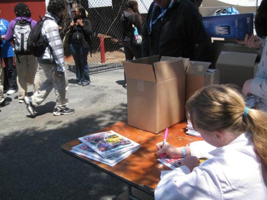 Sylvia signing magazines