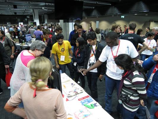 Sylvia describing how her robot works to a group of enthralled patrons to the Mozilla Science Faire at MozFest 2013 in London, UK.