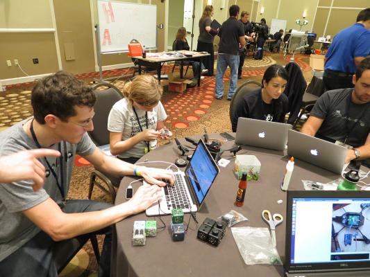 RobotsConf!! I wasn't really doing anything helpful here, but it as still fun hacking the cubelets. Check out the Gallery on G+ for more photos! Sylvia dissasembles a Cubelet robot at the hacking table to extract a servo while at RobotsConf 2013 in Florida.