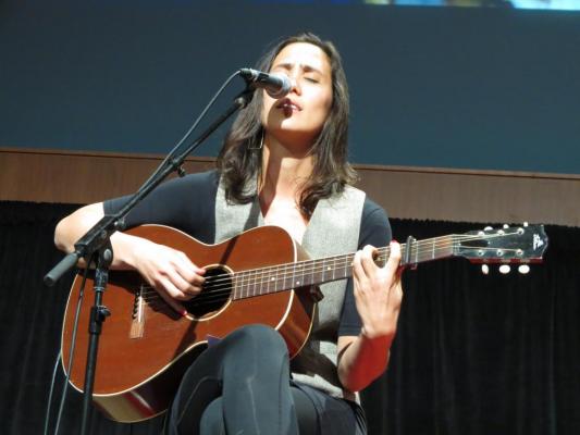 Megan Keely singing on stage at TEDx San Jose CA