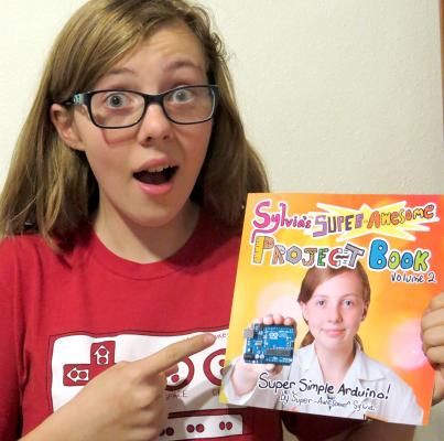 It's finally complete! WOOT!! Go check it out at superawesomebook.com Sylvia pointing at a physical copy of her new book, "Sylvia's Super Awesome Project Book: Super-Simple Arduino"