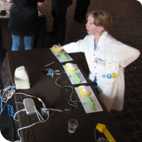 Sylvia pushes a button on one of the squishy circuit control panels