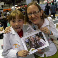 Sylvia posing with Lenore Edman and a picture of them from Maker Faire 2011