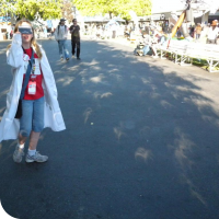 Sylvia squinting at the sun through darkened plastic to view the solar eclipse