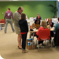 Attendees of TEDx San Jose talking to Sylvia during the lunch break