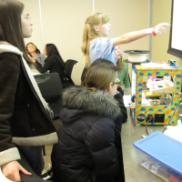 Sylvia instructs a volunteer on how to use Tinkercad to create a 3D model