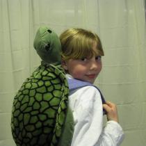 Sylvia poses with her turtle backpack buddy