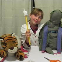 Sylvia poses with her backpack buddy tiger and turtle