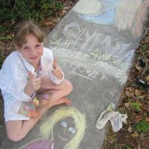 Sylvia with chalk mural on sidealk
